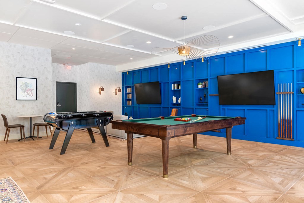 A room with a pool table and a TV.at The Vale at the Parks, Washington District of Columbia  