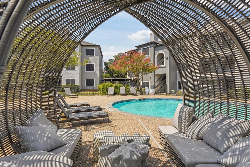 A large outdoor seating area with a pool and a building in the background. A large outdoor seating area with a pool and a building in the background.at Onyx183, Austin, TX