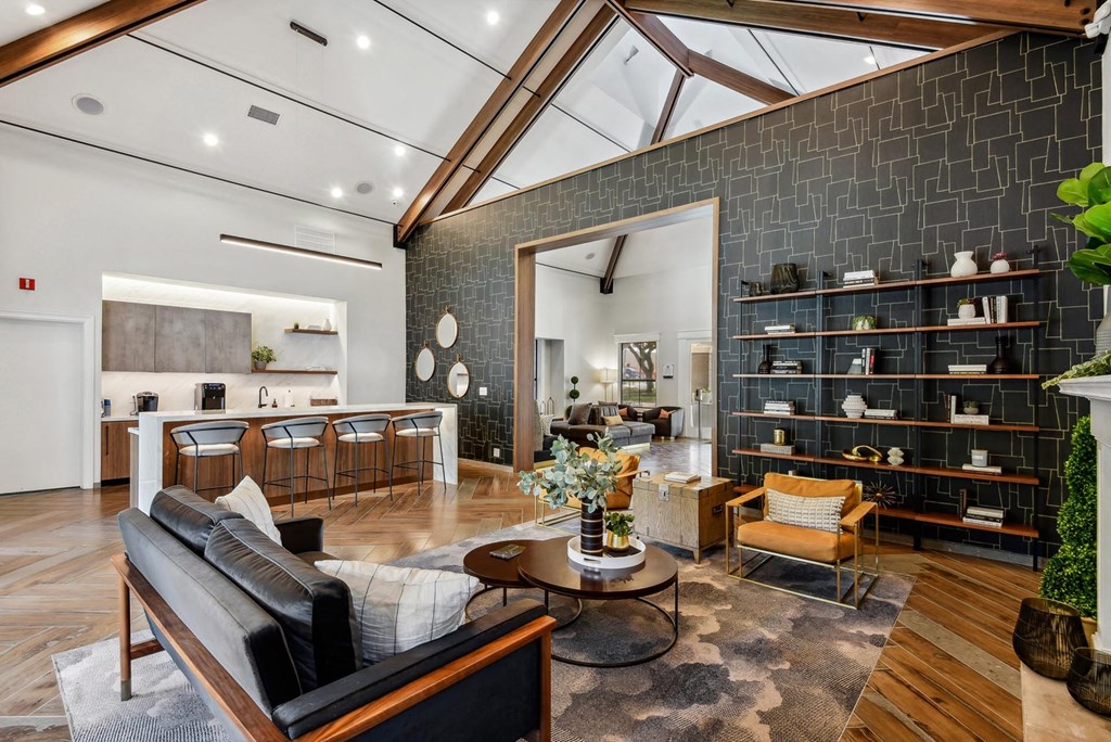 A modern living room with a black couch and a wooden coffee table. A modern living room with a black couch and a wooden coffee table.at Onyx183, Texas, 78729