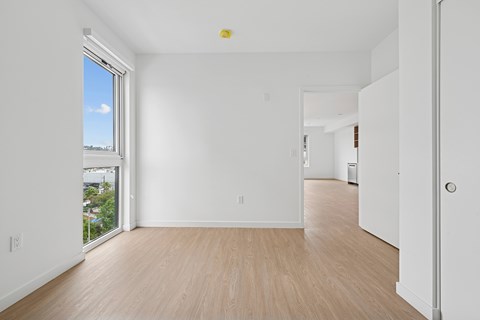 A room with a window and wooden floors.at 1915 Park, Los Angeles