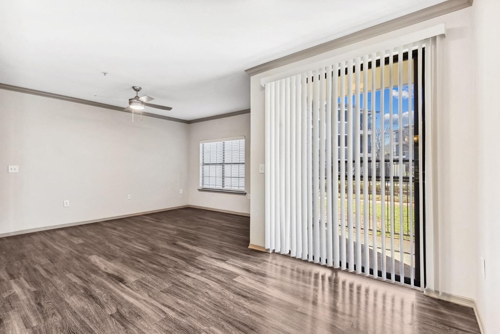 A room with a sliding door and a ceiling fan. A room with a sliding door and a ceiling fan.at Onyx183, Austin Texas