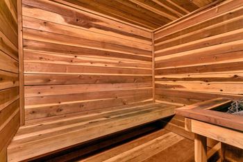 A wooden sauna with a bench and a table. at The Lex At Lowry, Colorado