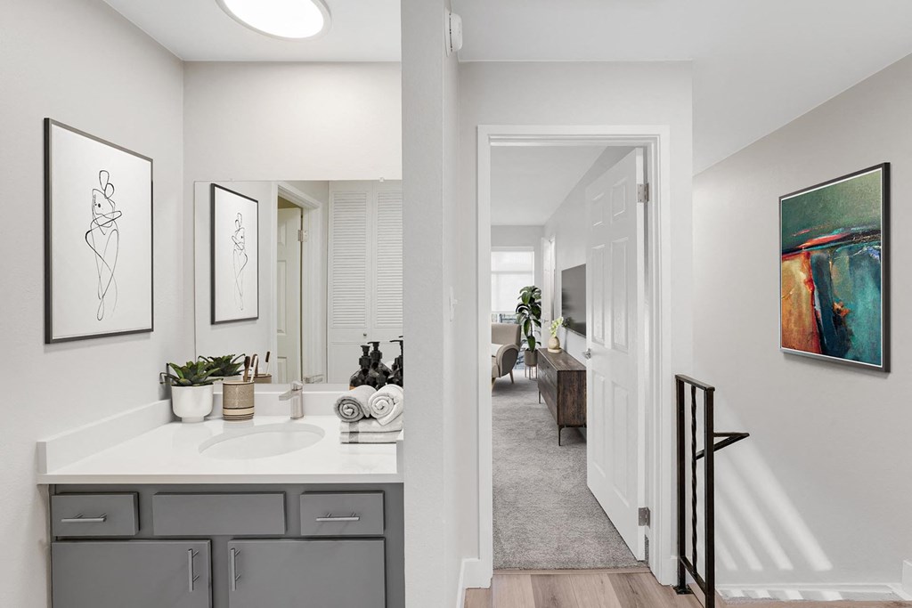 A bathroom with a white countertop and a white sink. at The Lex At Lowry, Denver