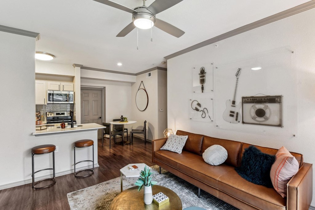 A living room with a brown leather couch and a coffee table in front of it. A living room with a brown leather couch and a coffee table in front of it.at Onyx183, Texas