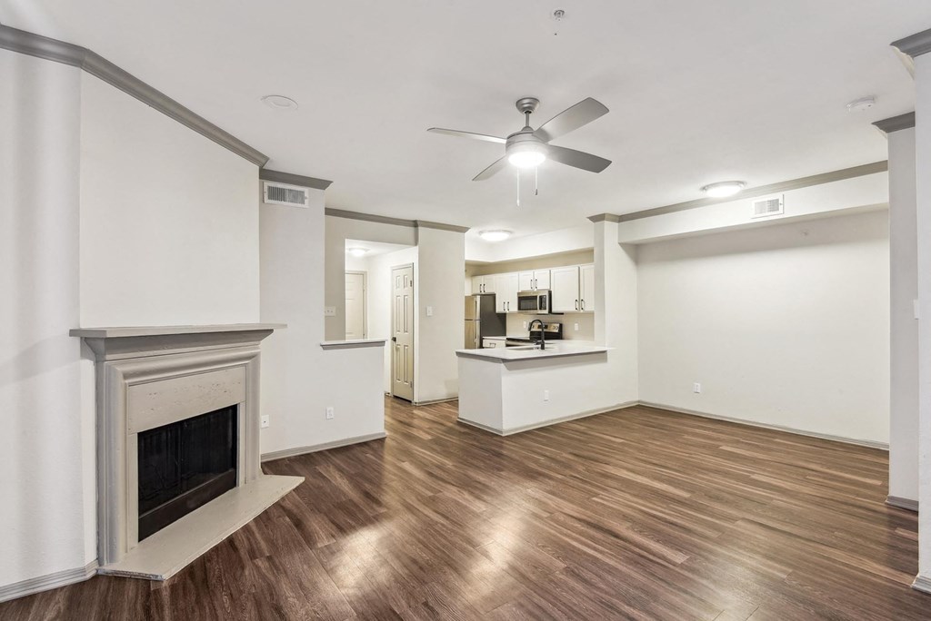 A room with a fireplace and a ceiling fan. A room with a fireplace and a ceiling fan.at Onyx183, Austin, TX 78729
