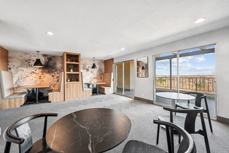 A modern living room with a black marble table and chairs. at The Lex At Lowry, Colorado
