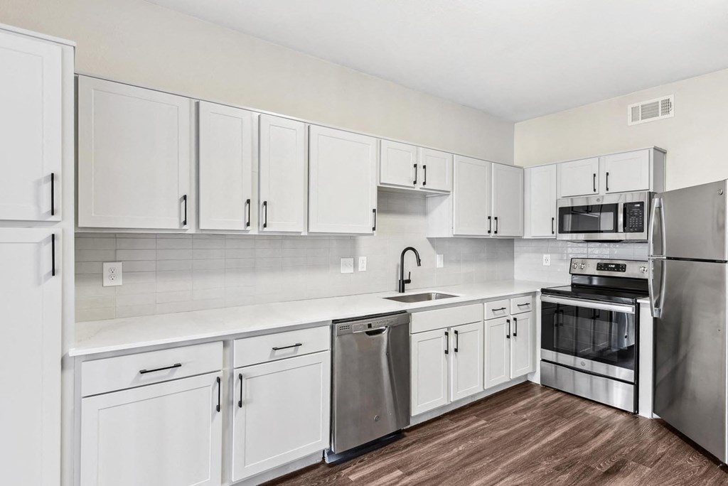 A kitchen with white cabinets and stainless steel appliances. A kitchen with white cabinets and stainless steel appliances.at Onyx183, Austin