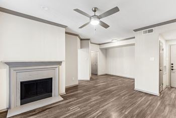 A room with a fireplace and a ceiling fan.at Onyx183, Austin Texas  