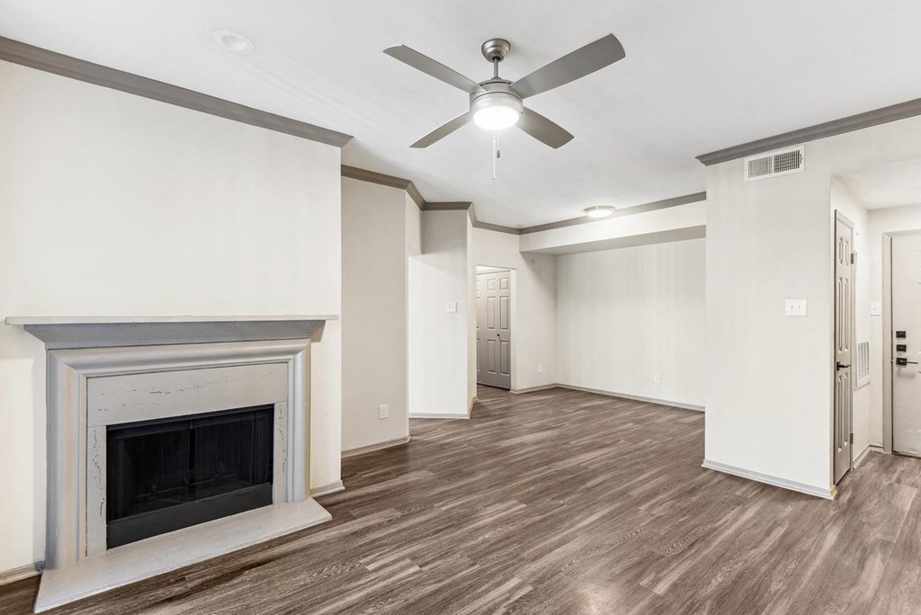 A room with a fireplace and a ceiling fan. A room with a fireplace and a ceiling fan.at Onyx183, Austin, 78729