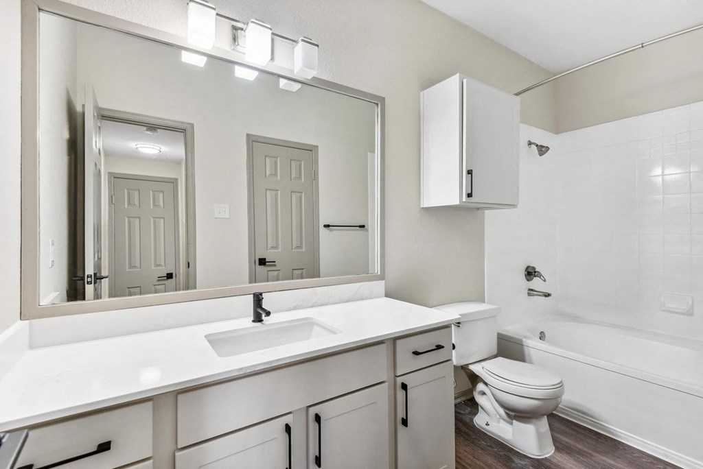 A white bathroom with a sink, toilet, and bathtub. A white bathroom with a sink, toilet, and bathtub.at Onyx183, Austin