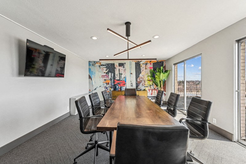 A conference room with a long table and chairs. at The Lex At Lowry, Denver, Colorado