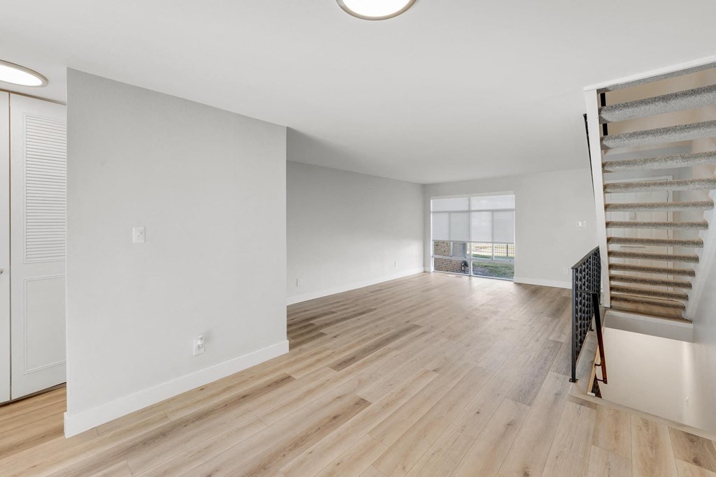 A room with wooden floors and white walls. at The Lex At Lowry, Denver