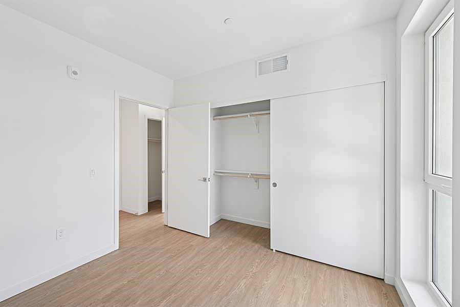 A white room with a doorway leading to another room.
