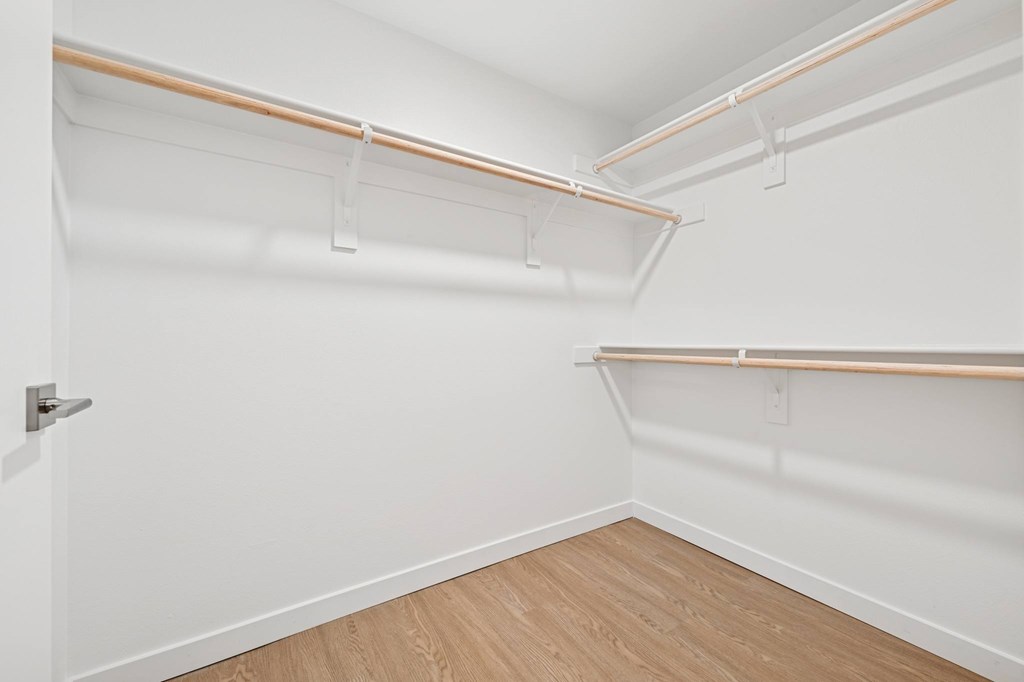 A white closet with a door and shelves at Coro Apartments, Los Angeles, CA 90016