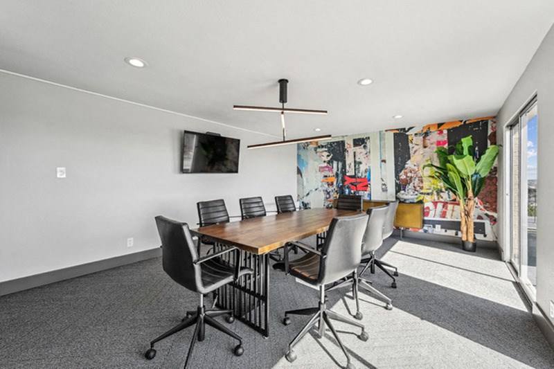 A conference room with a long table and chairs. at The Lex At Lowry, Denver, Colorado