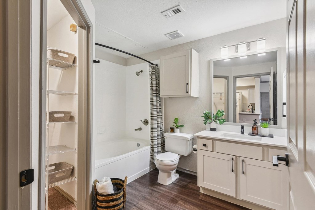 A bathroom with a toilet, sink, and mirror. A bathroom with a toilet, sink, and mirror.at Onyx183, Austin, TX 78729