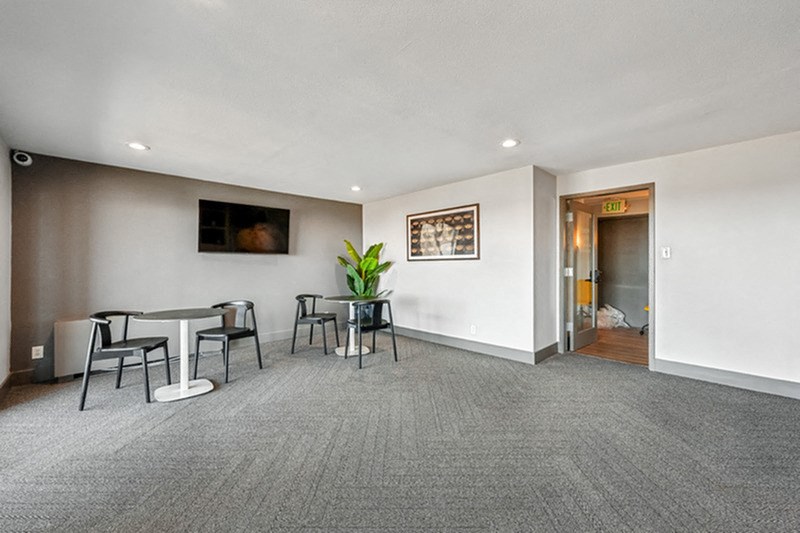 A conference room with a table and chairs and a plant. at The Lex At Lowry, Denver