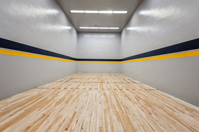 A long wooden table with a yellow and black stripe on the side. at The Lex At Lowry, Denver, Colorado