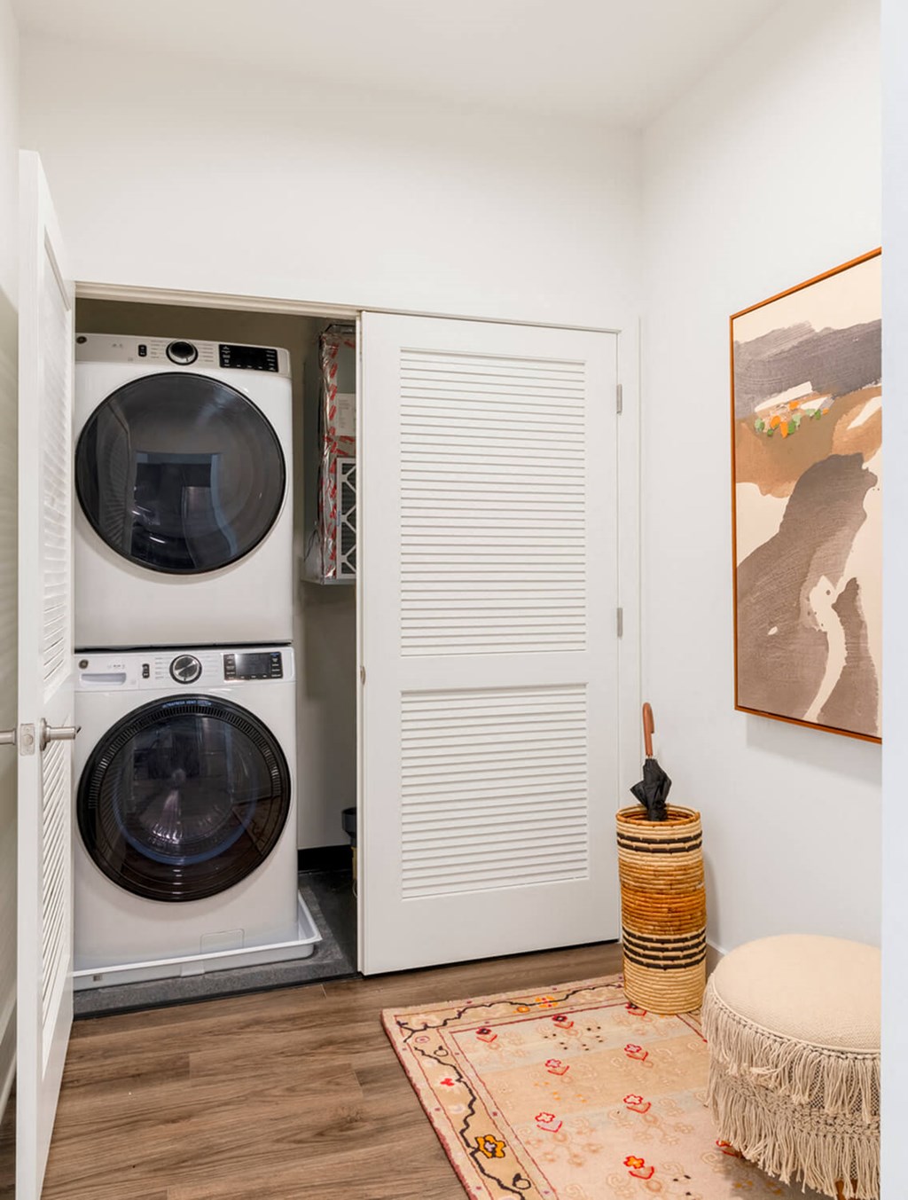 A washing machine is in a small laundry room.at The Vale at the Parks, Washington  