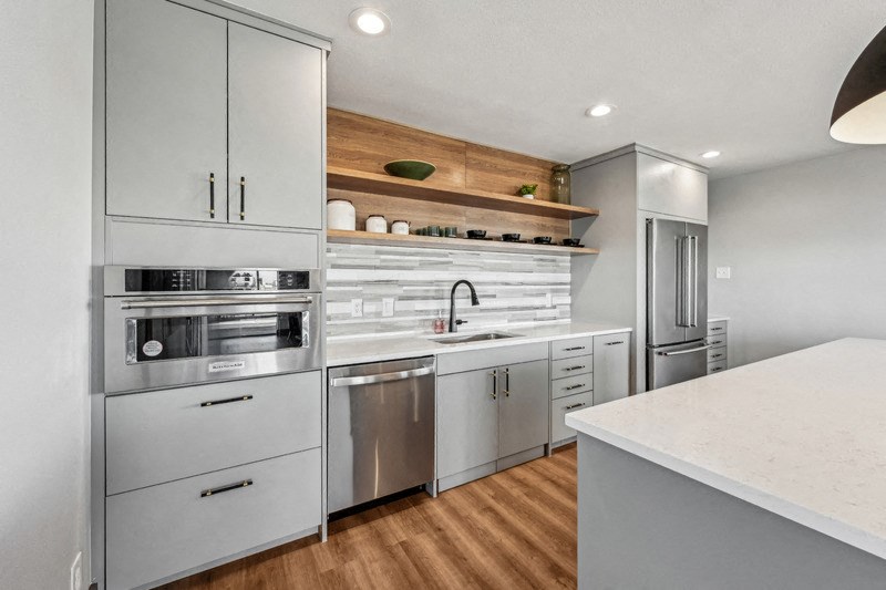 A modern kitchen with stainless steel appliances and wooden accents. at The Lex At Lowry, Denver, Colorado