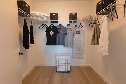 A white wall with clothes hanging on it.
