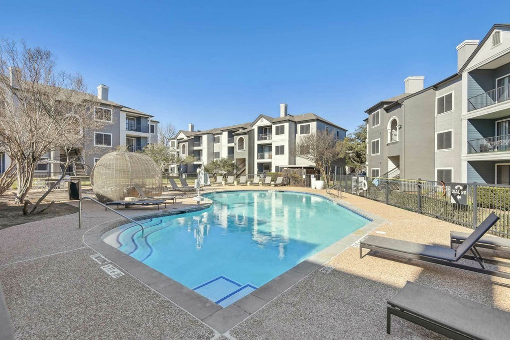 A pool surrounded by apartment buildings and a sun lounger. A pool surrounded by apartment buildings and a sun lounger.at Onyx183, Austin