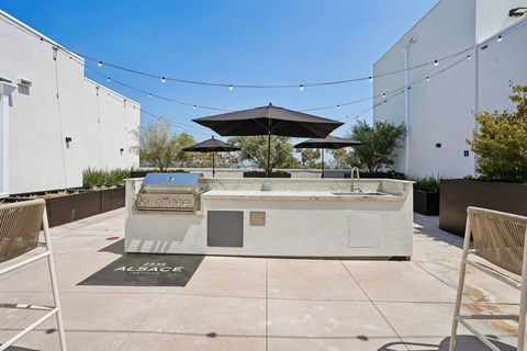 A patio area with a hot tub and chairs.