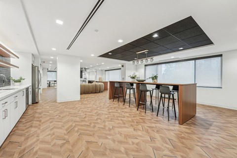 A modern kitchen with a dining table and chairs.
