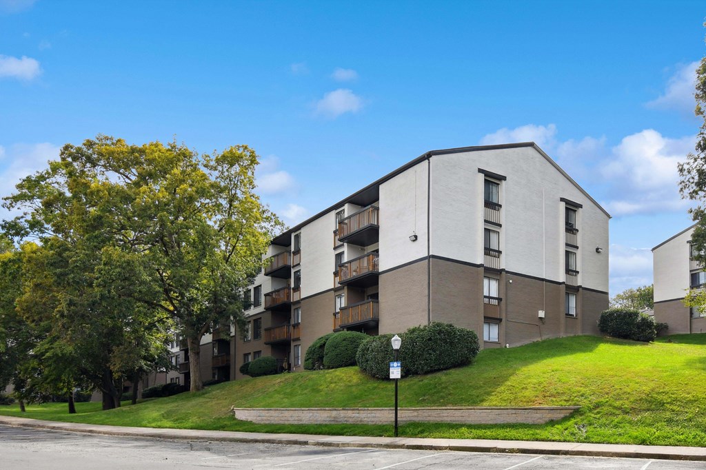 Apartment building with a tree in front of it.