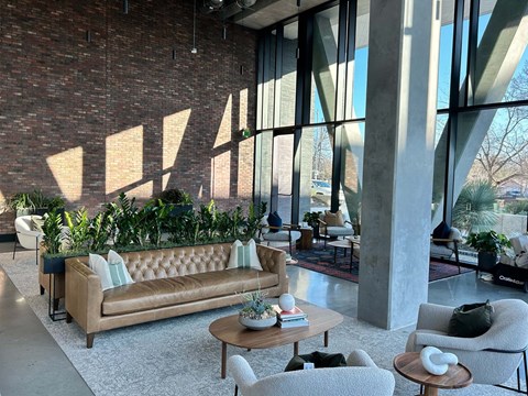 A living room with a couch, chairs, and a coffee table.