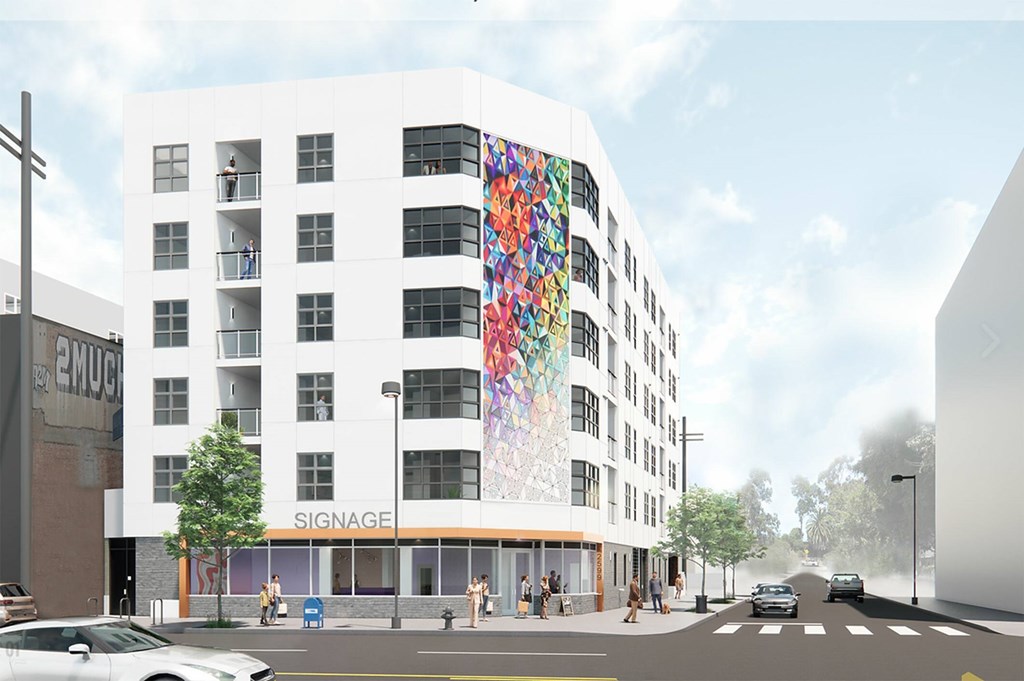 A white building with a colorful mural on the side.