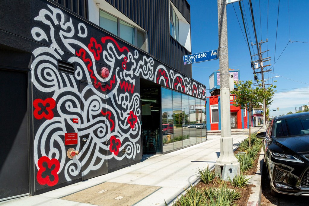 A black and red mural on the side of a building.