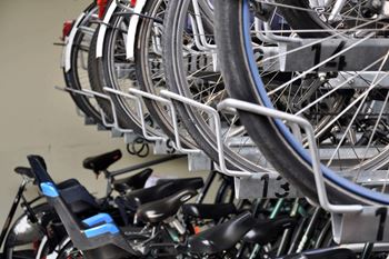 A bunch of bicycles are parked in a bike rack.