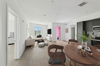 A modern living room with a brown wooden table and chairs.