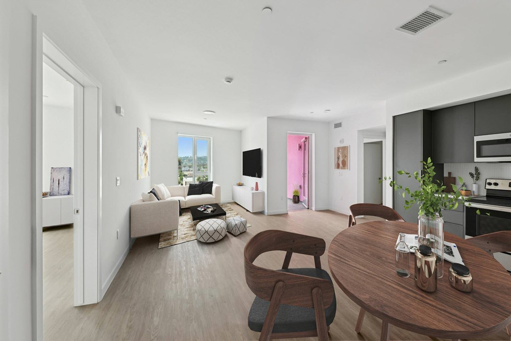 A modern living room with a brown wooden table and chairs.