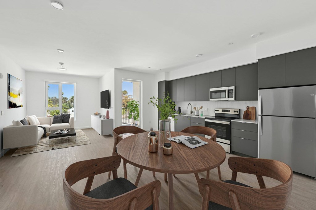 A modern kitchen with a dining table and chairs.