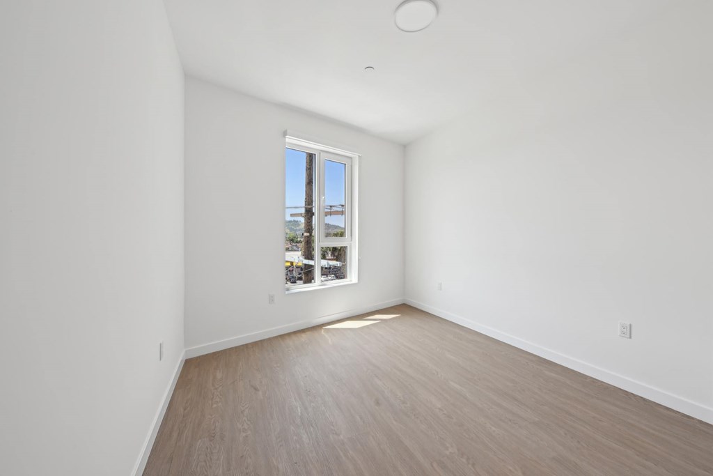 A room with a window overlooking a cityscape.