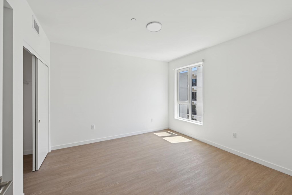 A room with a window and a door.