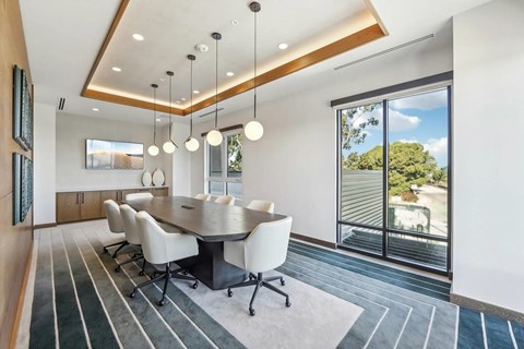A modern dining room with a large table and chairs.