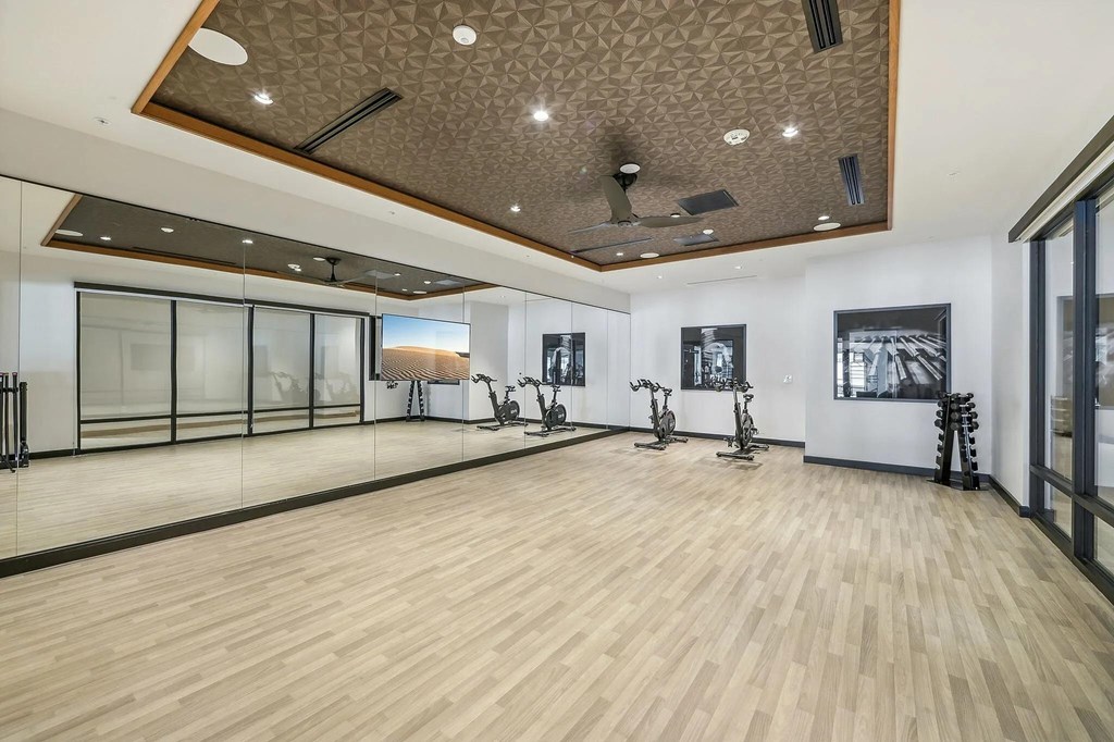 Fitness center with yoga and stretching area at Bayview Apartments, Emeryville, California, 94608