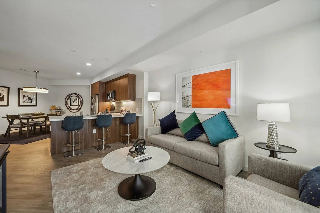 Living room with kitchen view at Bayview Apartments, Emeryville, CA