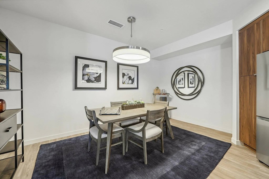 Dining table with wooden chairs at Bayview Apartments, Emeryville, CA
