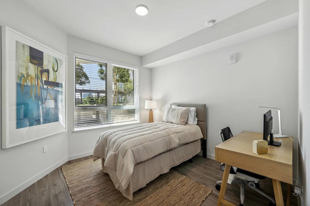 Bedroom with a desk and chair at Bayview Apartments, Emeryville