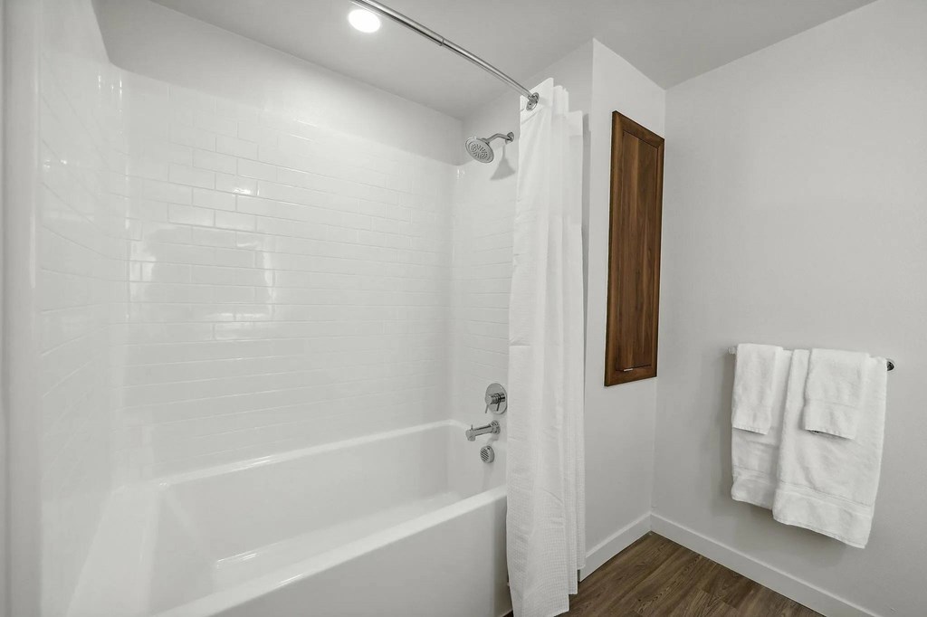 Bathroom with shower and curtain at Bayview Apartments, Emeryville, 94608