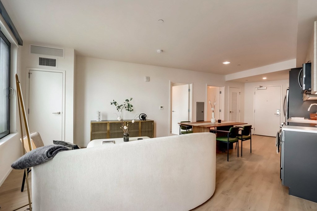 A modern living room with a white sofa and a wooden floor.at Channel House, Oakland, CA 94607