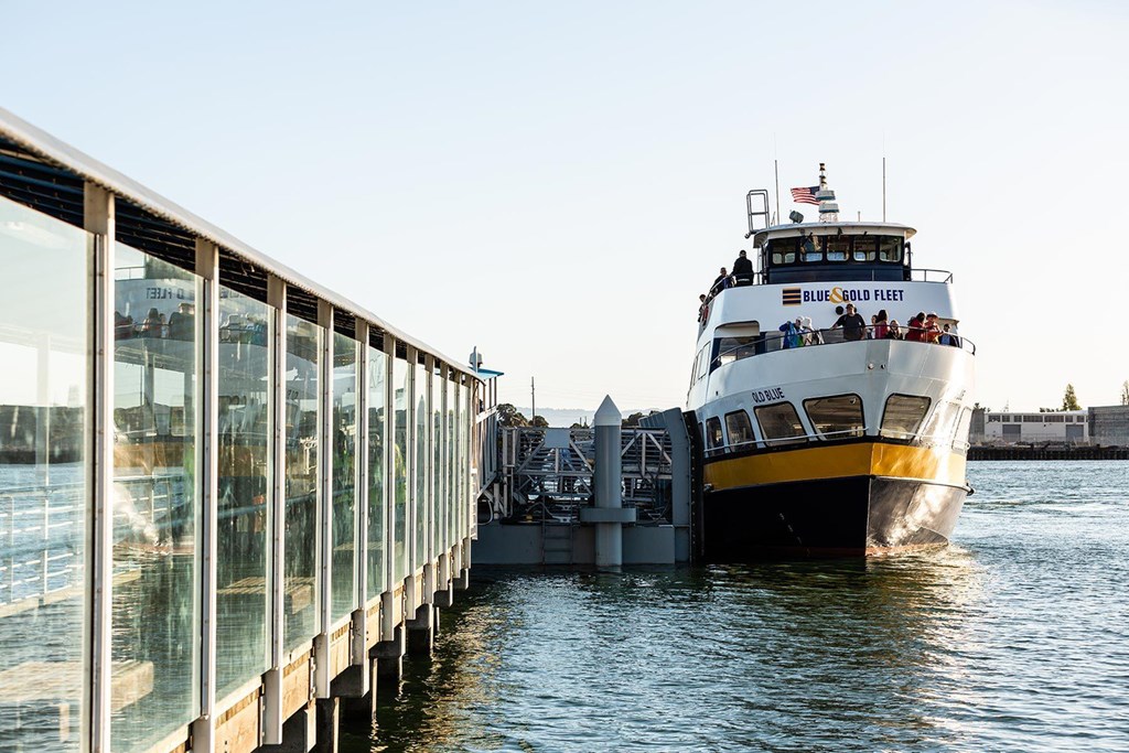 A large boat named Blue Frog Fleet is docked at a pier.at Channel House, California, 94607