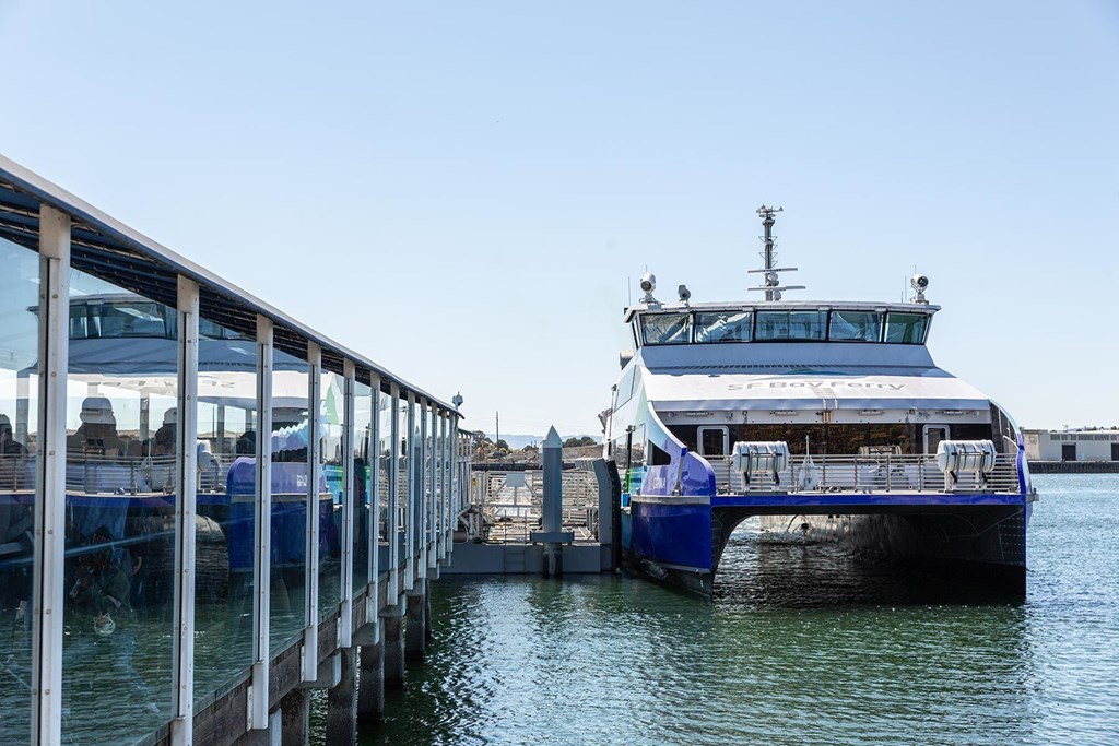 A large white boat is docked at a pier.at Channel House, Oakland, CA