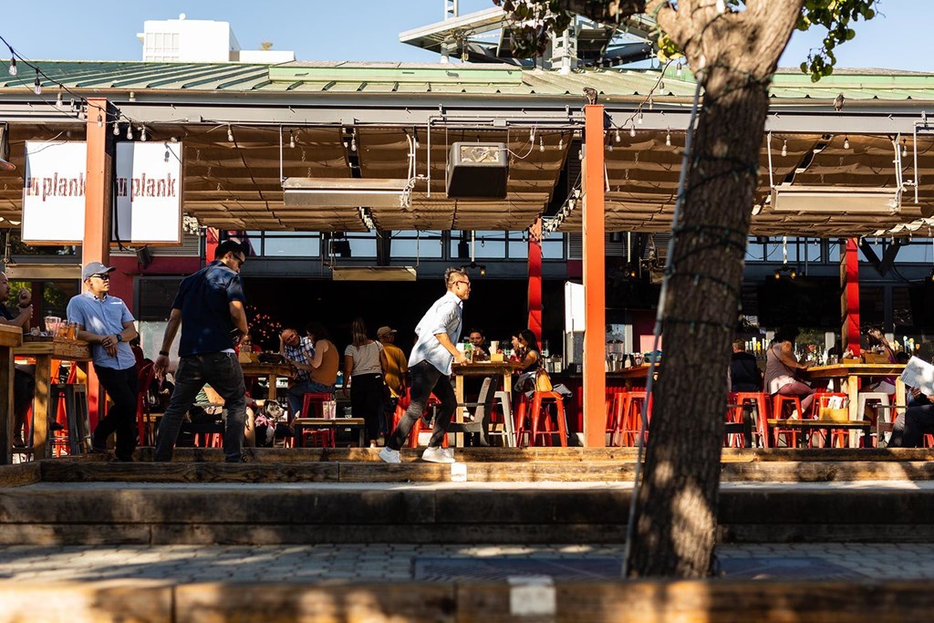 A man is walking in front of a restaurant.at Channel House, Oakland California