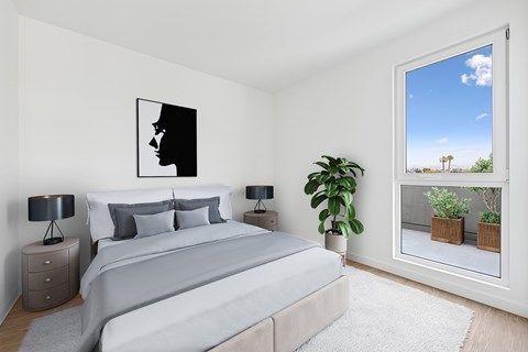 A bedroom with a large bed and a painting on the wall at Coro Apartments, California 90016