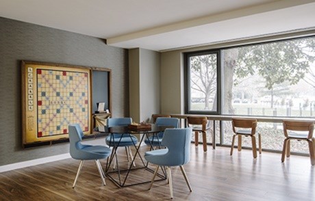A dining room with a large table and chairs.